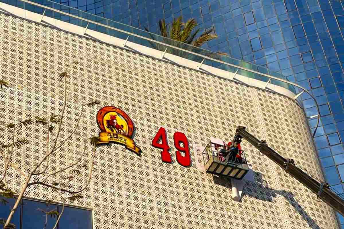 High-access building facade signage and hospitality branding for 49er's (SFC Group) at Al Reem Island, Abu Dhabi.