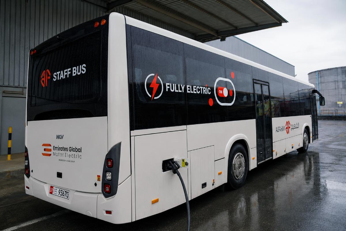 Electric staff bus with vinyl cut lettering and decals, full side view, Abu Dhabi