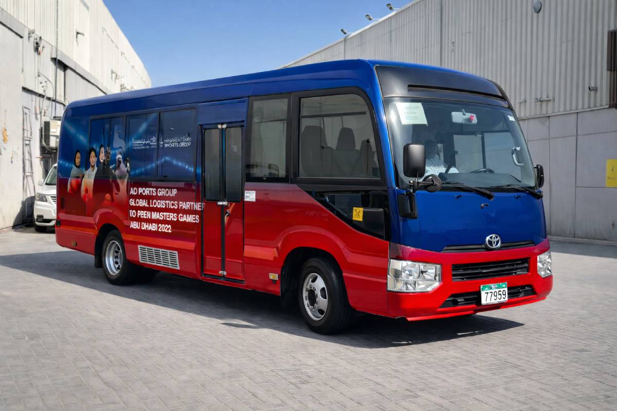 AD Ports Group full bus branding with custom red and blue vehicle wrap in Abu Dhabi