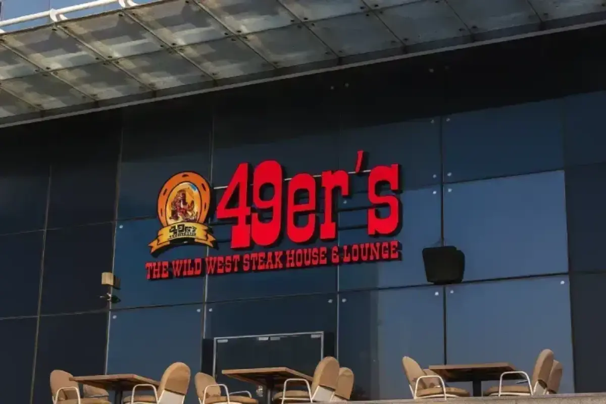 Professional signage installation in Abu Dhabi featuring a 3D signboard of  49er's SFC group  done By Ninety Nine Advertising LLC
