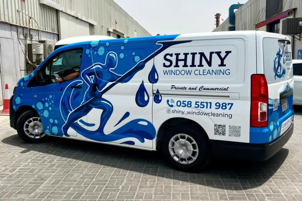 Shiny Window Cleaning partial vehicle branding with blue water graphics in Abu Dhabi