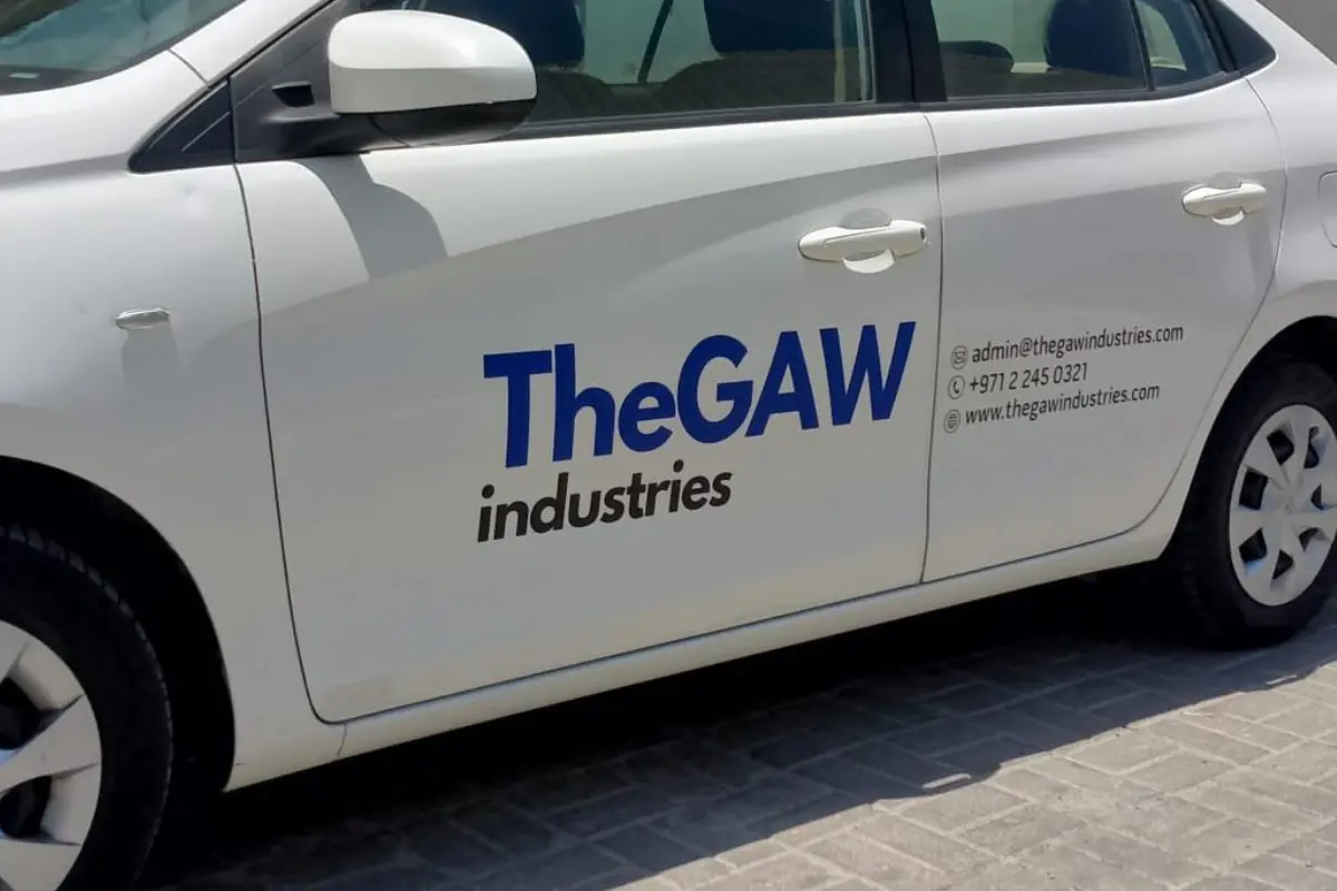 TheGAW Industries corporate fleet lettering applied to a white company car in Abu Dhabi